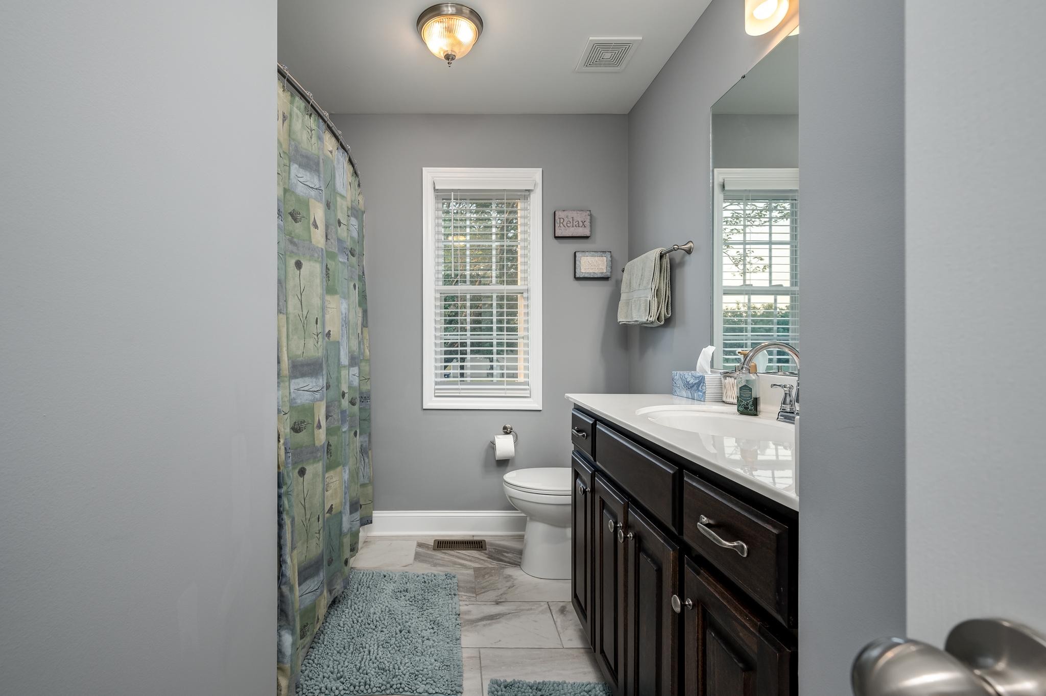 8284 Fredonia Road Manchester, TN 37355 - Photo 13 of 25 a spacious bathroom with a granite countertop sink a toilet and a window