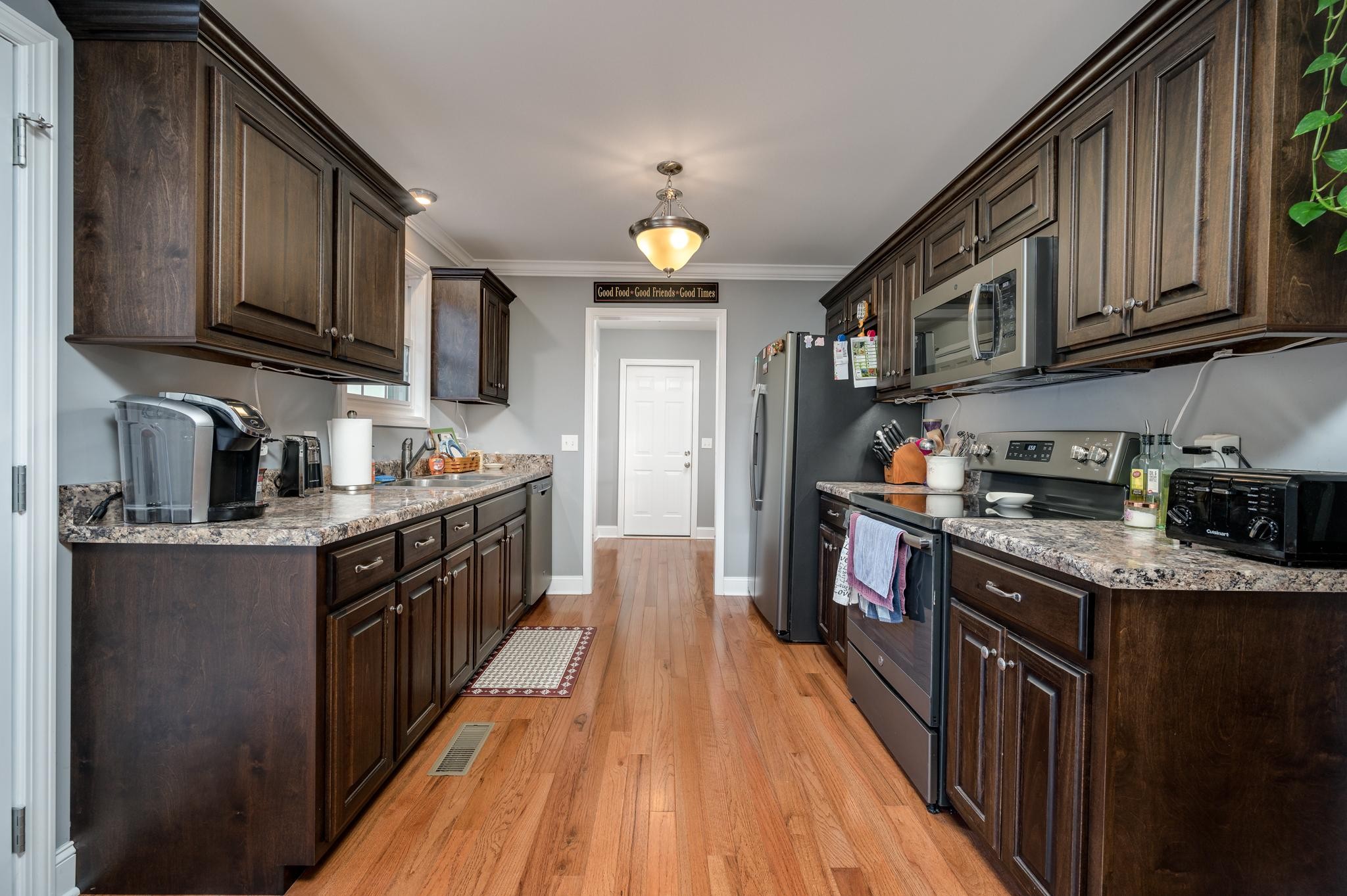 8284 Fredonia Road Manchester, TN 37355 - Photo 8 of 25 a kitchen with stainless steel appliances granite countertop wooden cabinets a stove top oven a sink and dishwasher