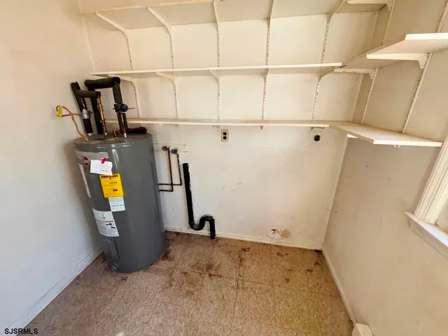 a view of storage and utility room with windows