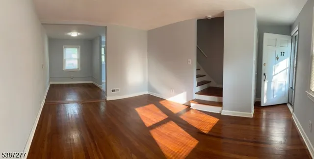 a kitchen with granite countertop white cabinets and a stove
