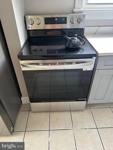 a view of a room that has wooden floor and window