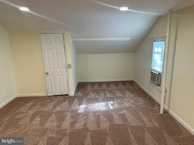 a view of backyard with wooden fence