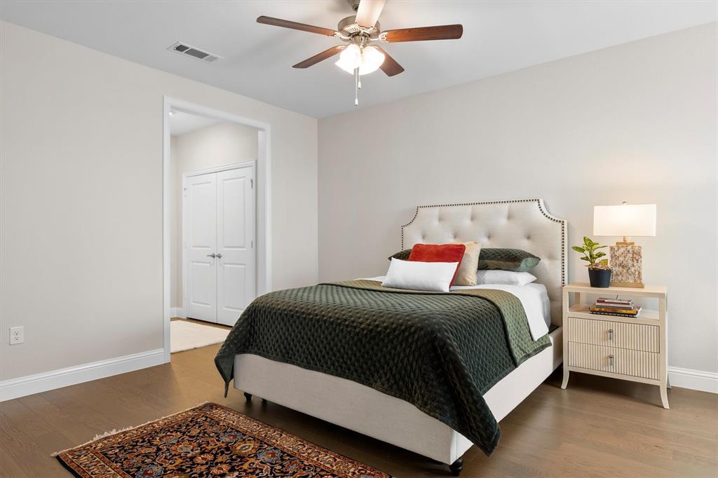 651 Watters Road, Unit 4403 Allen, TX 75013 - Photo 14 of 37 a bedroom with a bed and a chandelier
