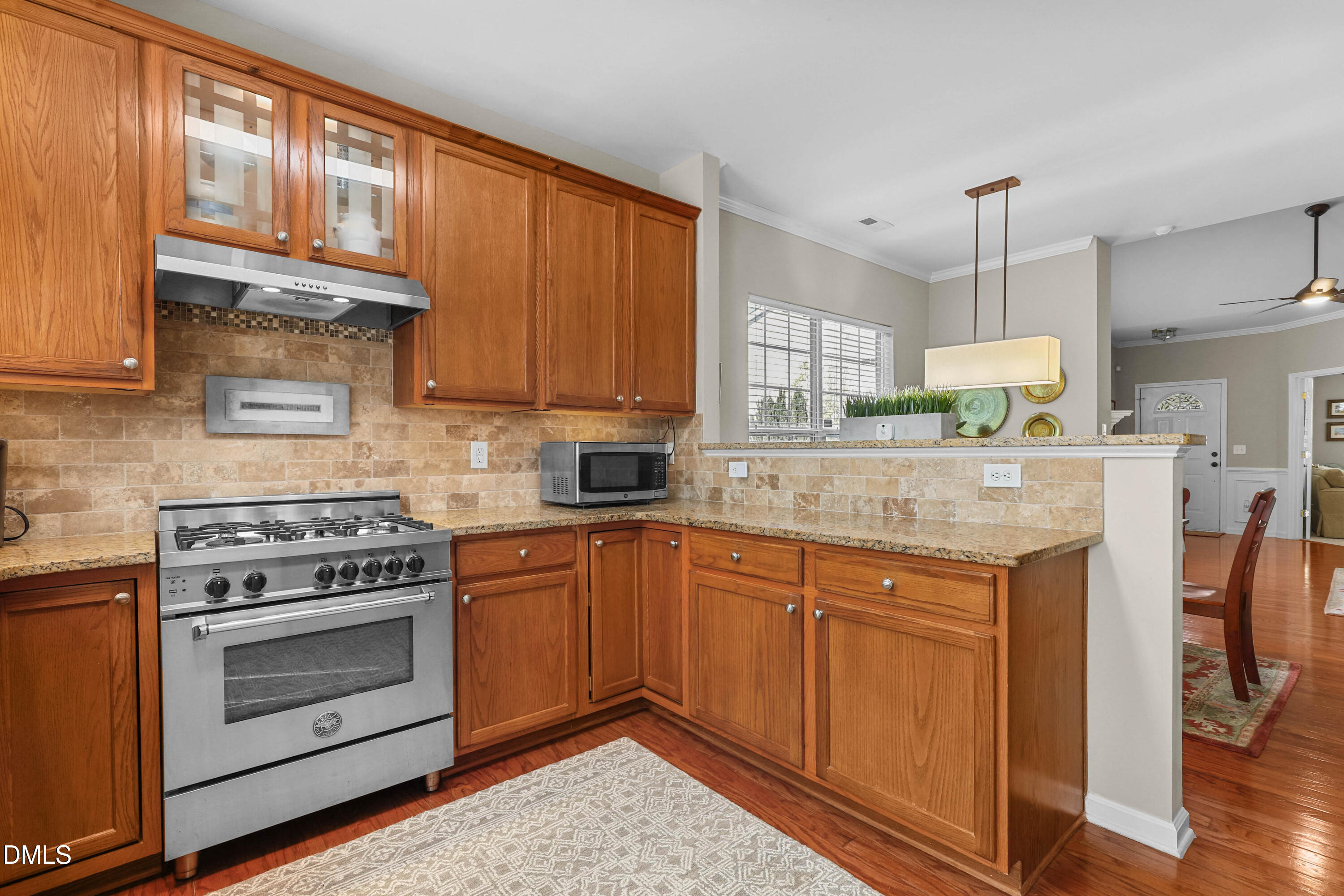 2005 Misty Fog Court Raleigh, NC 27603 - Photo 14 of 42 a kitchen with stainless steel appliances granite countertop a stove a sink and cabinets