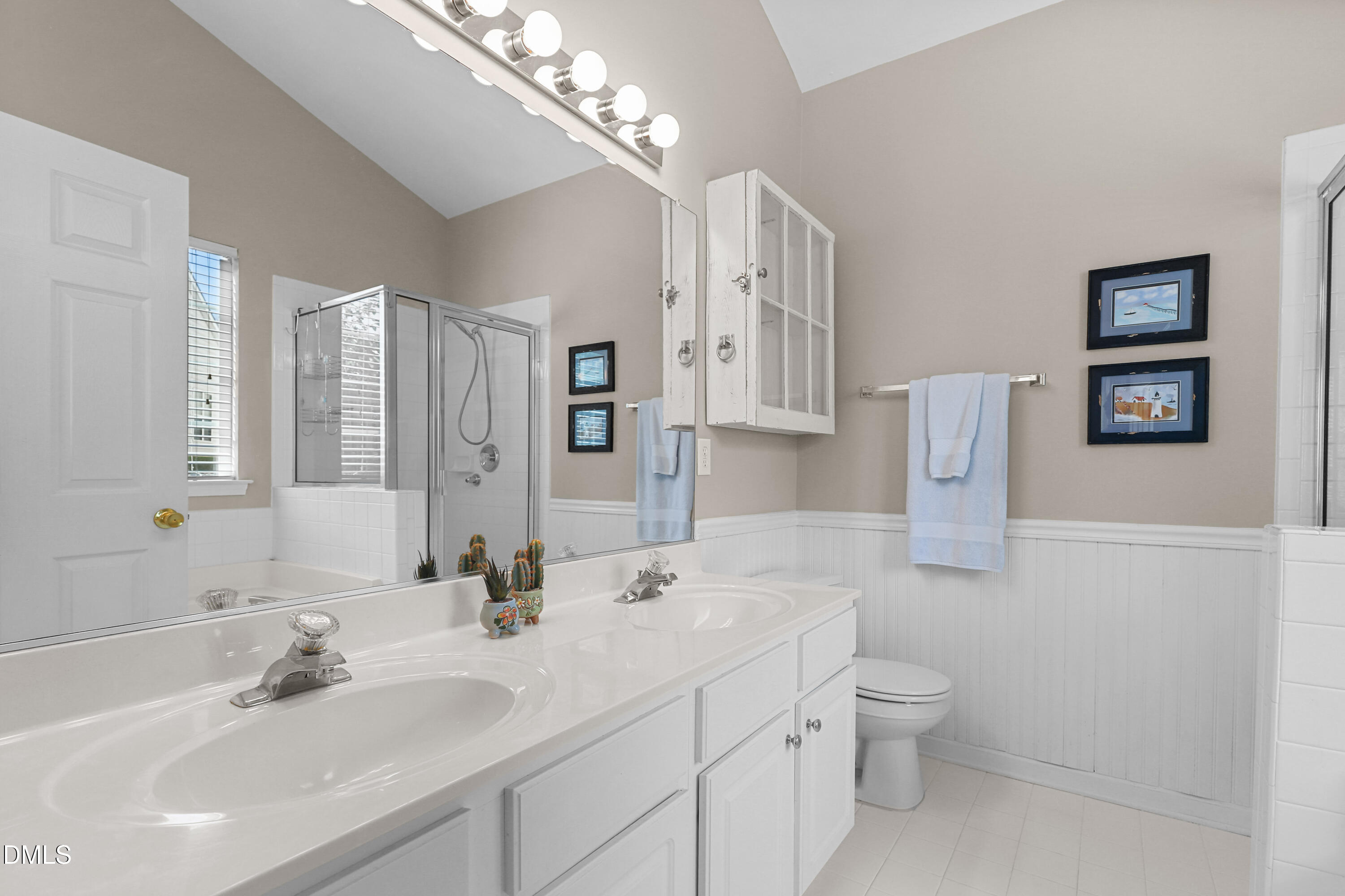 2005 Misty Fog Court Raleigh, NC 27603 - Photo 21 of 42 a bathroom with 2 sink toilet and a mirror