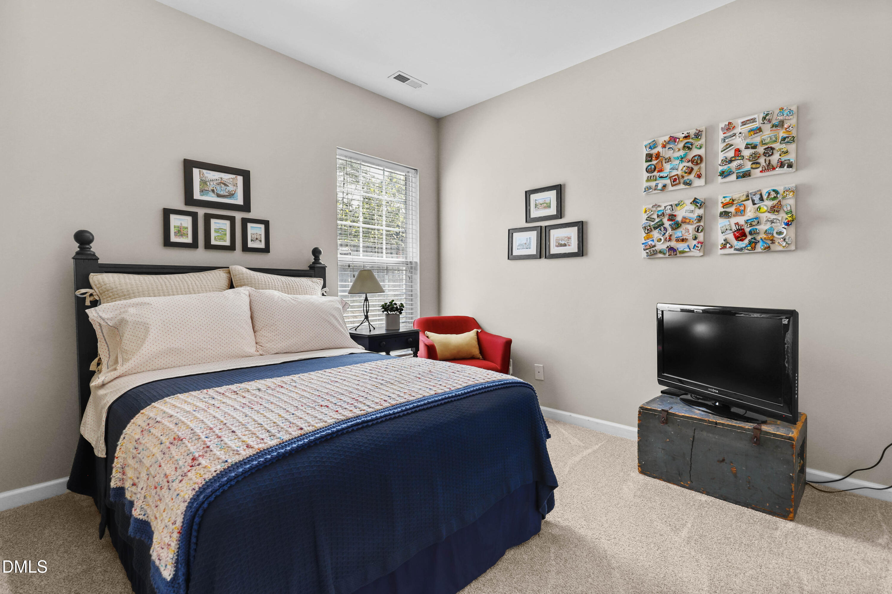 2005 Misty Fog Court Raleigh, NC 27603 - Photo 25 of 42 a bedroom with a bed and a flat screen tv