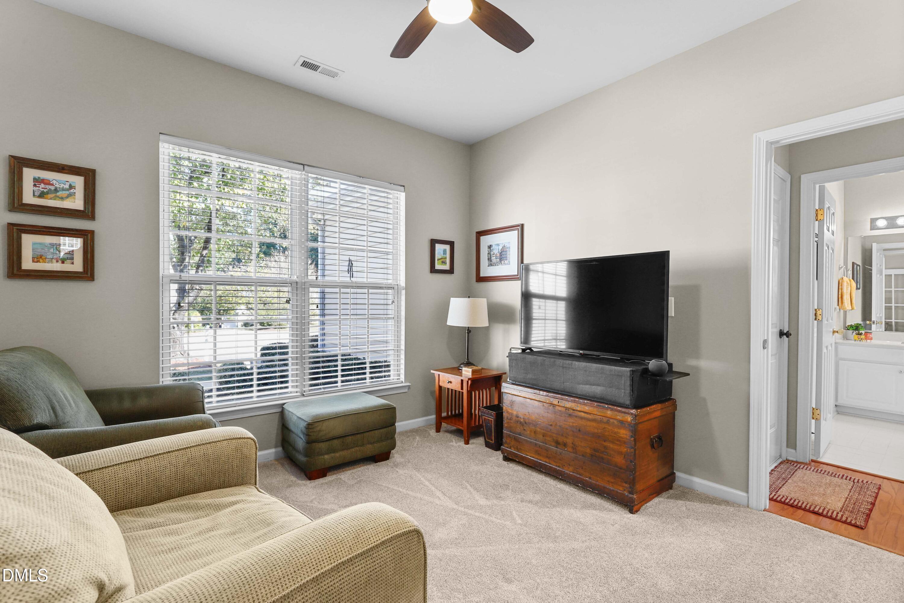 2005 Misty Fog Court Raleigh, NC 27603 - Photo 7 of 42 a living room with furniture and a flat screen tv