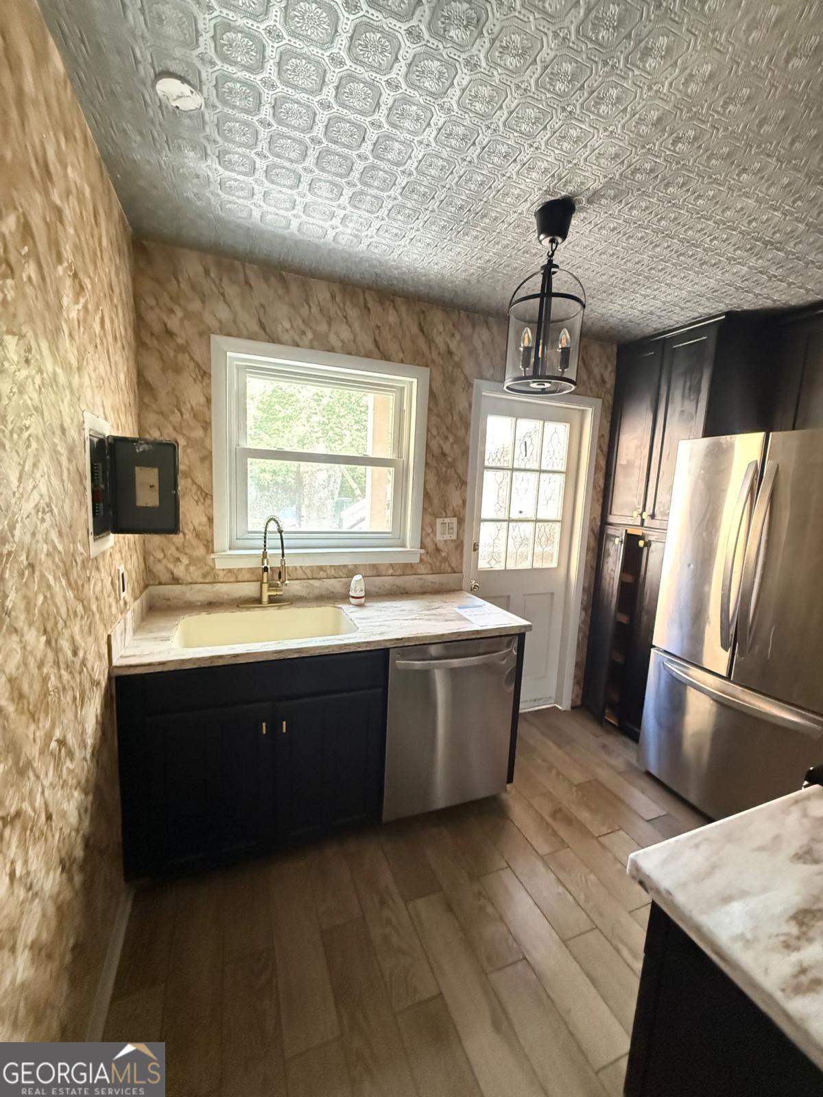 3510 Roswell Road, Unit H1 Atlanta, GA 30326 - Photo 22 of 43 a view of a kitchen with a sink and wooden floor