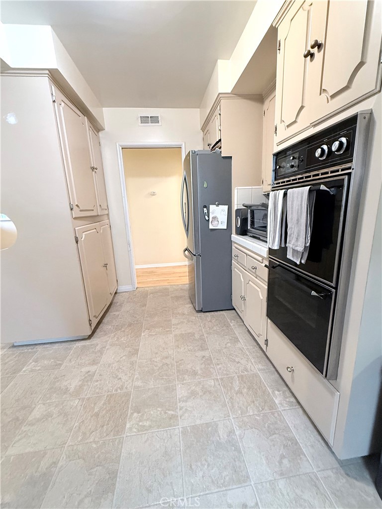 970 West 8th Street San Pedro, CA 90731 - Photo 11 of 22 a view of kitchen with refrigerator and microwave