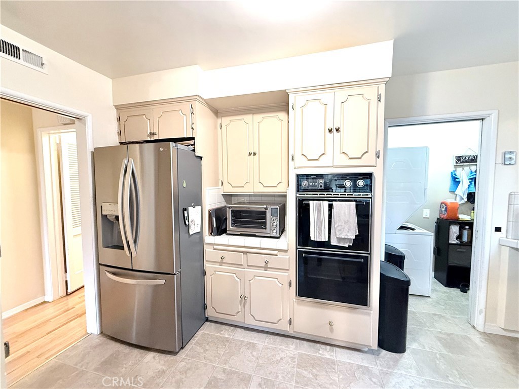 970 West 8th Street San Pedro, CA 90731 - Photo 10 of 22 a kitchen with stainless steel appliances a refrigerator a stove and a refrigerator