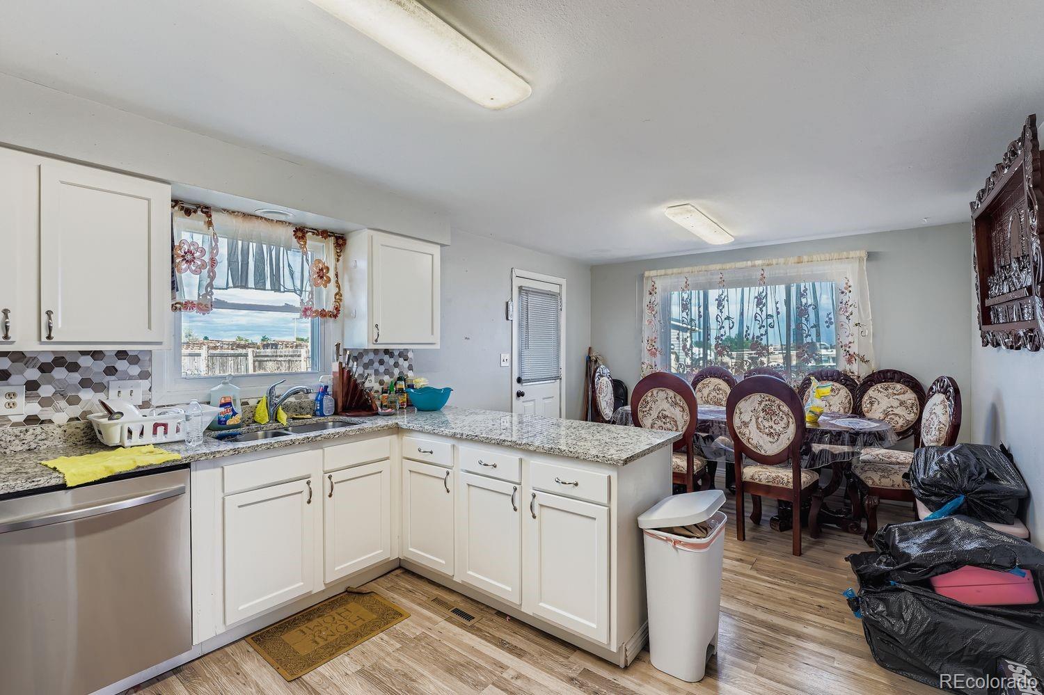361 East Thomas Avenue Byers, CO 80103 - Photo 12 of 28 a kitchen with a sink stove and cabinets