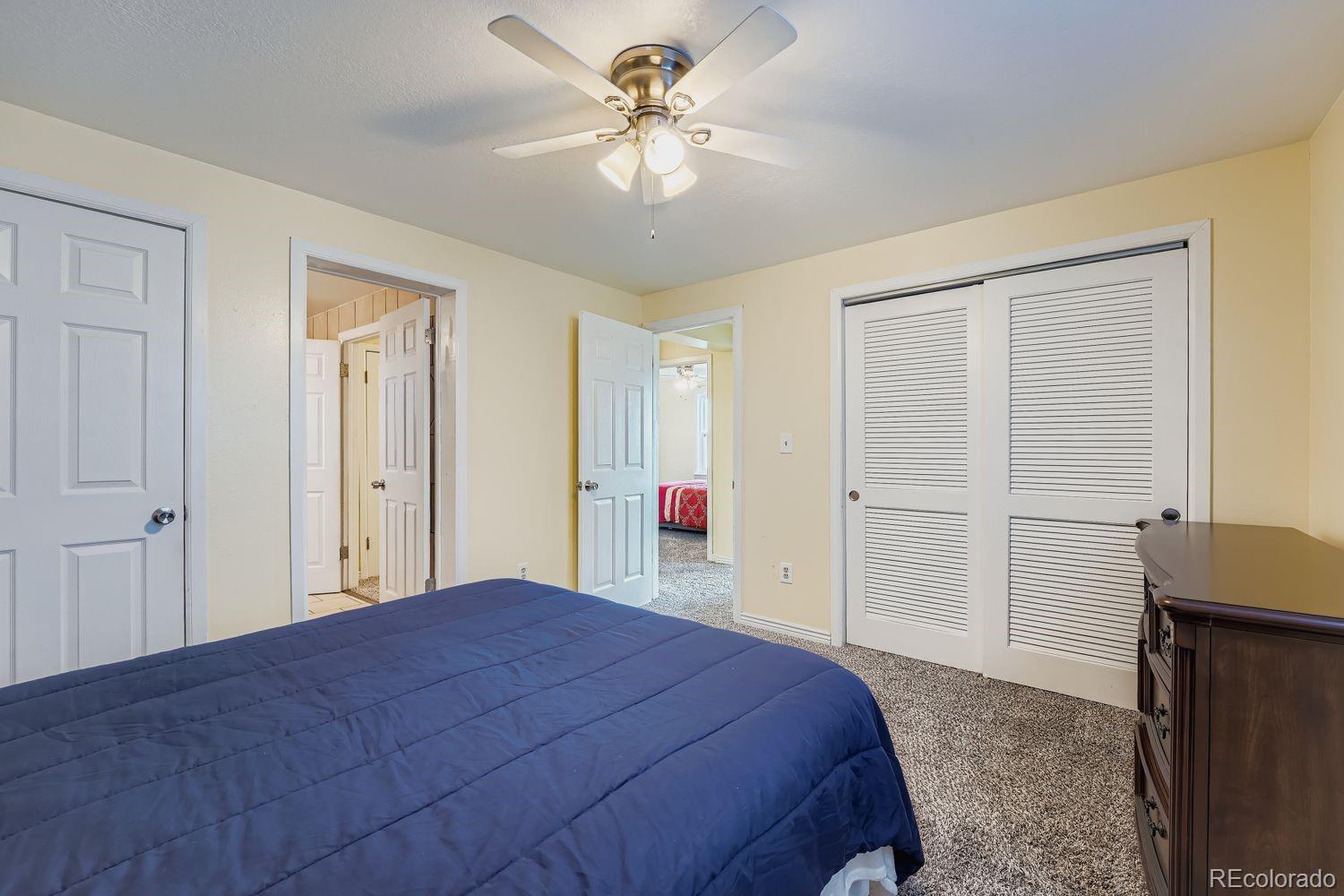 361 East Thomas Avenue Byers, CO 80103 - Photo 14 of 28 a bedroom with a bed and a chandelier