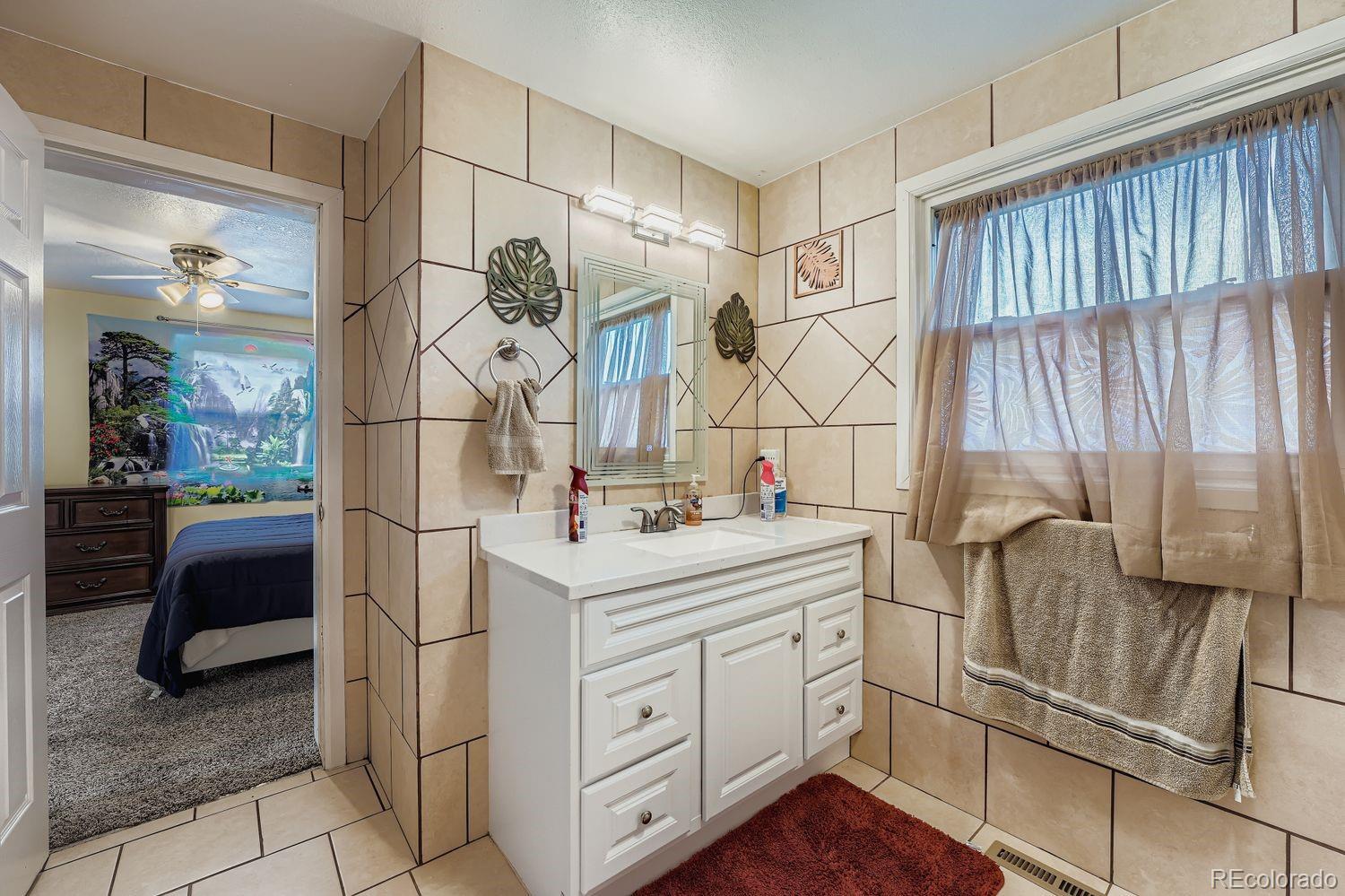 361 East Thomas Avenue Byers, CO 80103 - Photo 16 of 28 a bathroom with a sink and a mirror