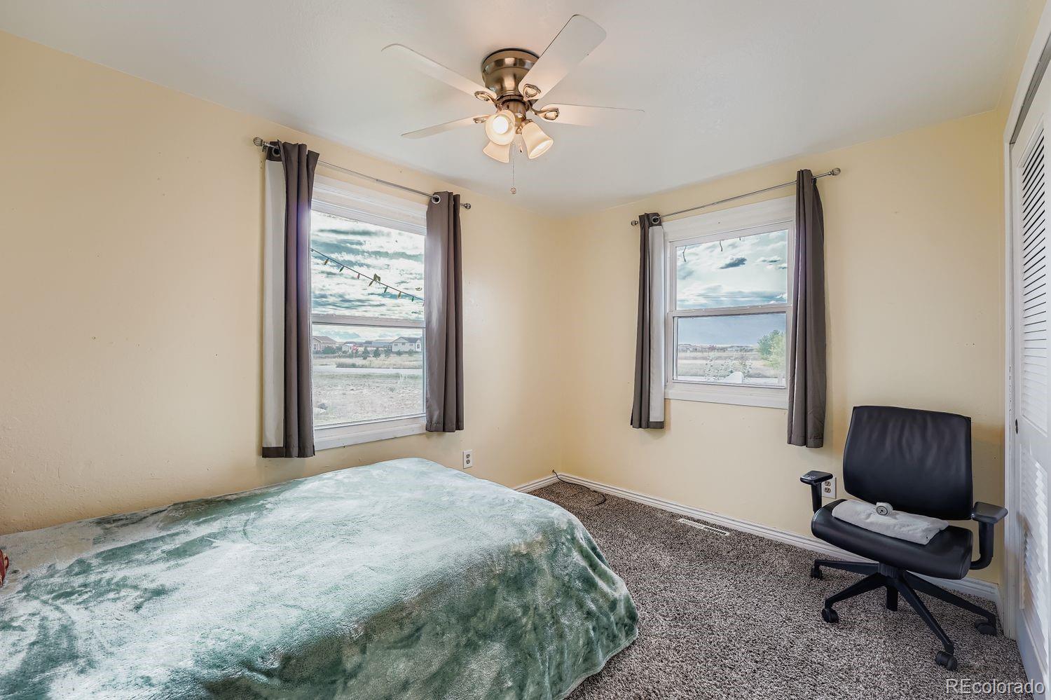 361 East Thomas Avenue Byers, CO 80103 - Photo 19 of 28 a bedroom with a bed and a chair