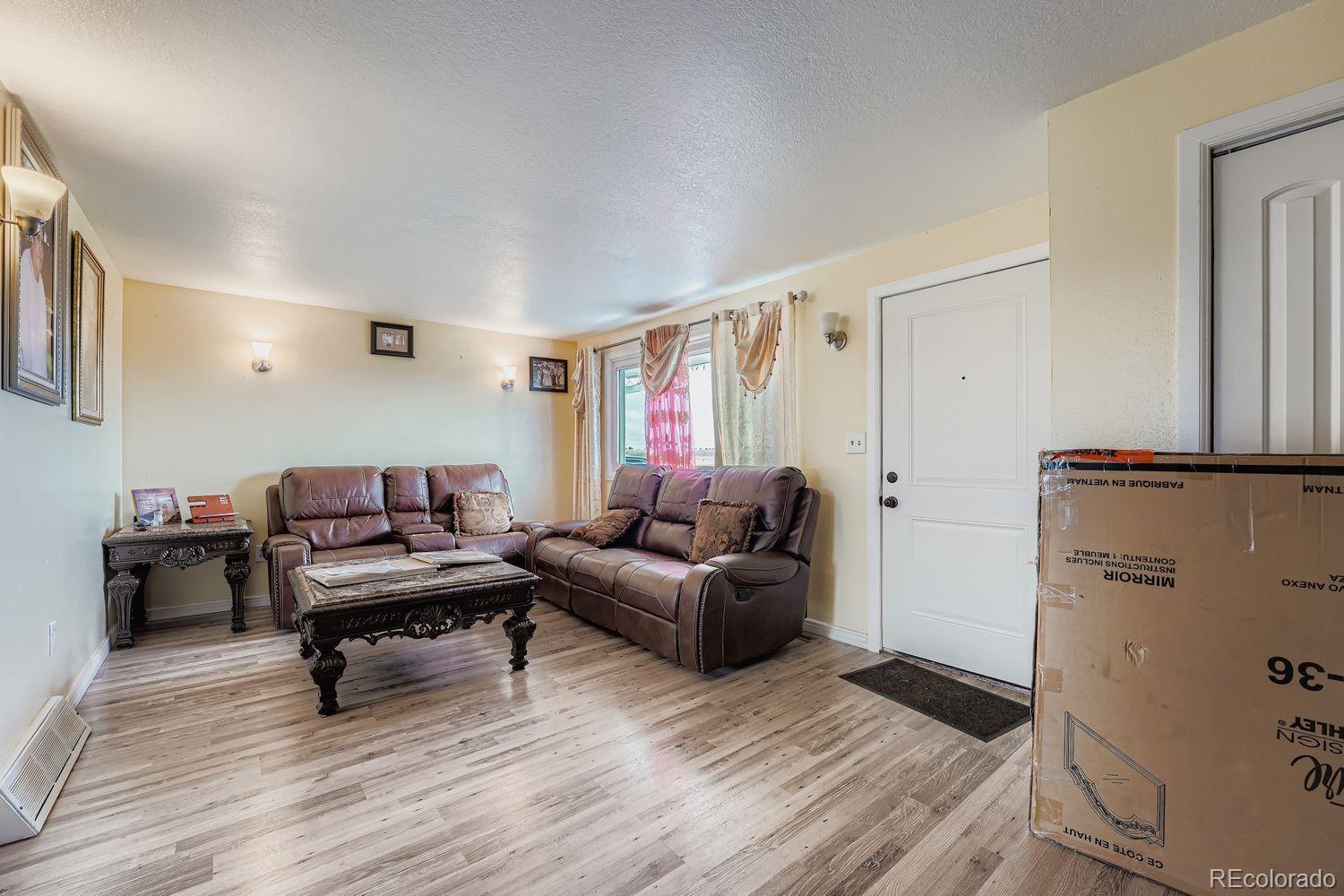 361 East Thomas Avenue Byers, CO 80103 - Photo 5 of 28 a living room with furniture and a wooden floor