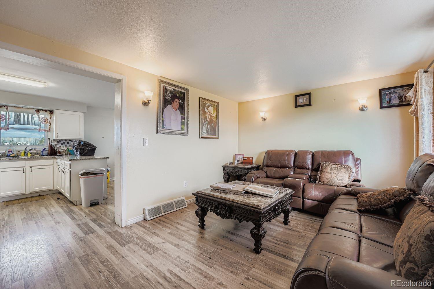 361 East Thomas Avenue Byers, CO 80103 - Photo 7 of 28 a living room with furniture and wooden floor