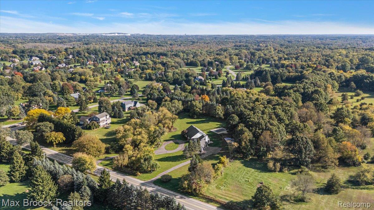 4597 Clarkston Road Clarkston, MI 48348 - Photo 66 of 74 Expansive property with a circular driveway, surrounded by mature trees and landscaped grounds