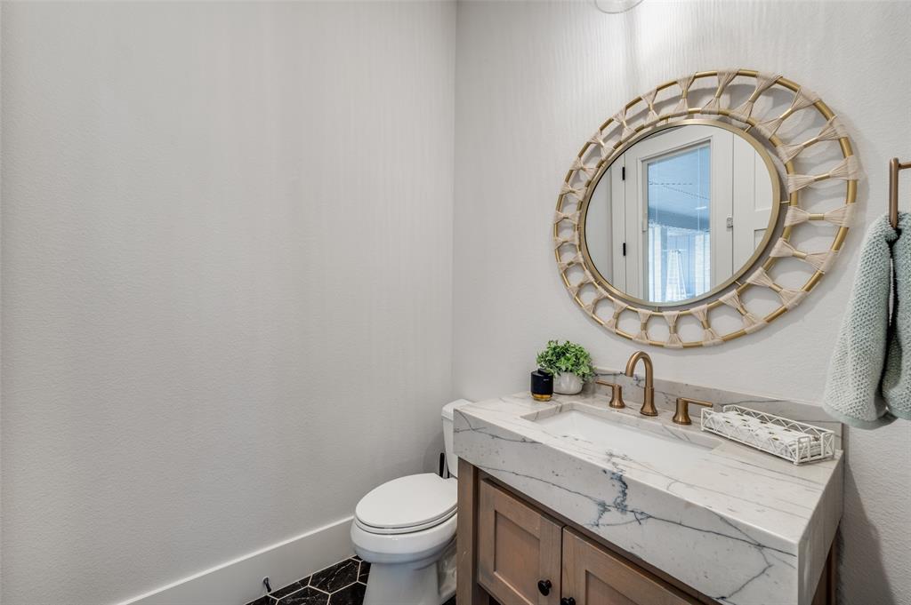 1459 Sunset Pt Drive Flower Mound, TX 75022 - Photo 15 of 38 a bathroom with a sink and a mirror