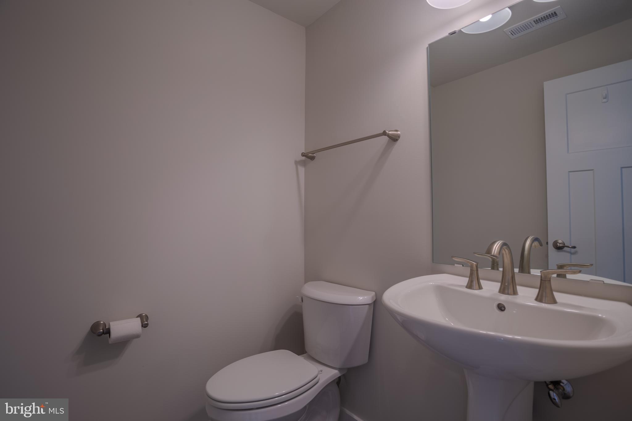 503 Boise Road Inwood, WV 25428 - Photo 52 of 83 a bathroom with a sink a toilet and a mirror