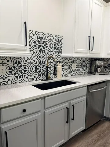 a sink with white cabinets