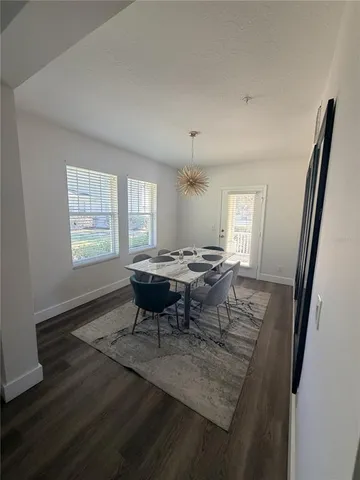 a view of a dining room with furniture and wooden floor