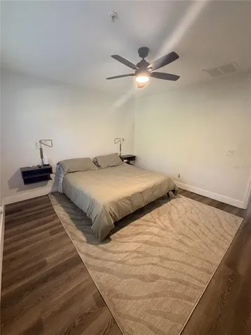 a bedroom with a bed and a ceiling fan