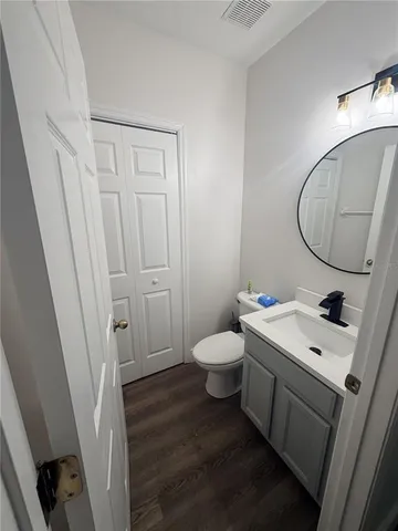 a bathroom with a sink a toilet and a mirror