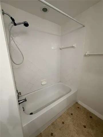 a bathroom with a tub and a shower