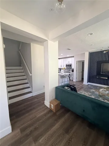a living room with hard wood flooring and furniture