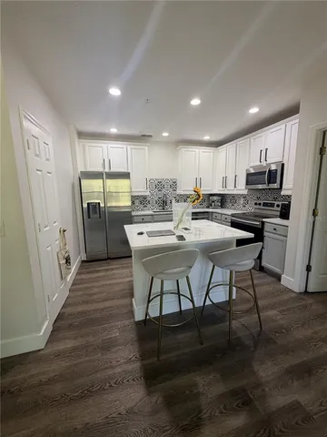 a view of a dining room kitchen and a wooden floor
