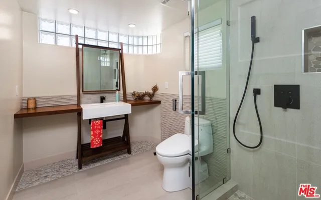 a bathroom with a sink toilet and shower