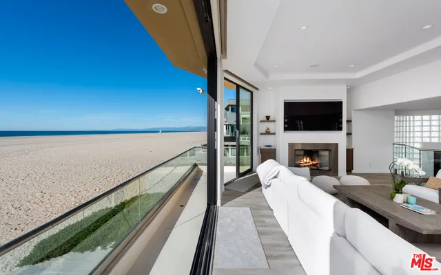 a view of a living room with furniture and a fireplace