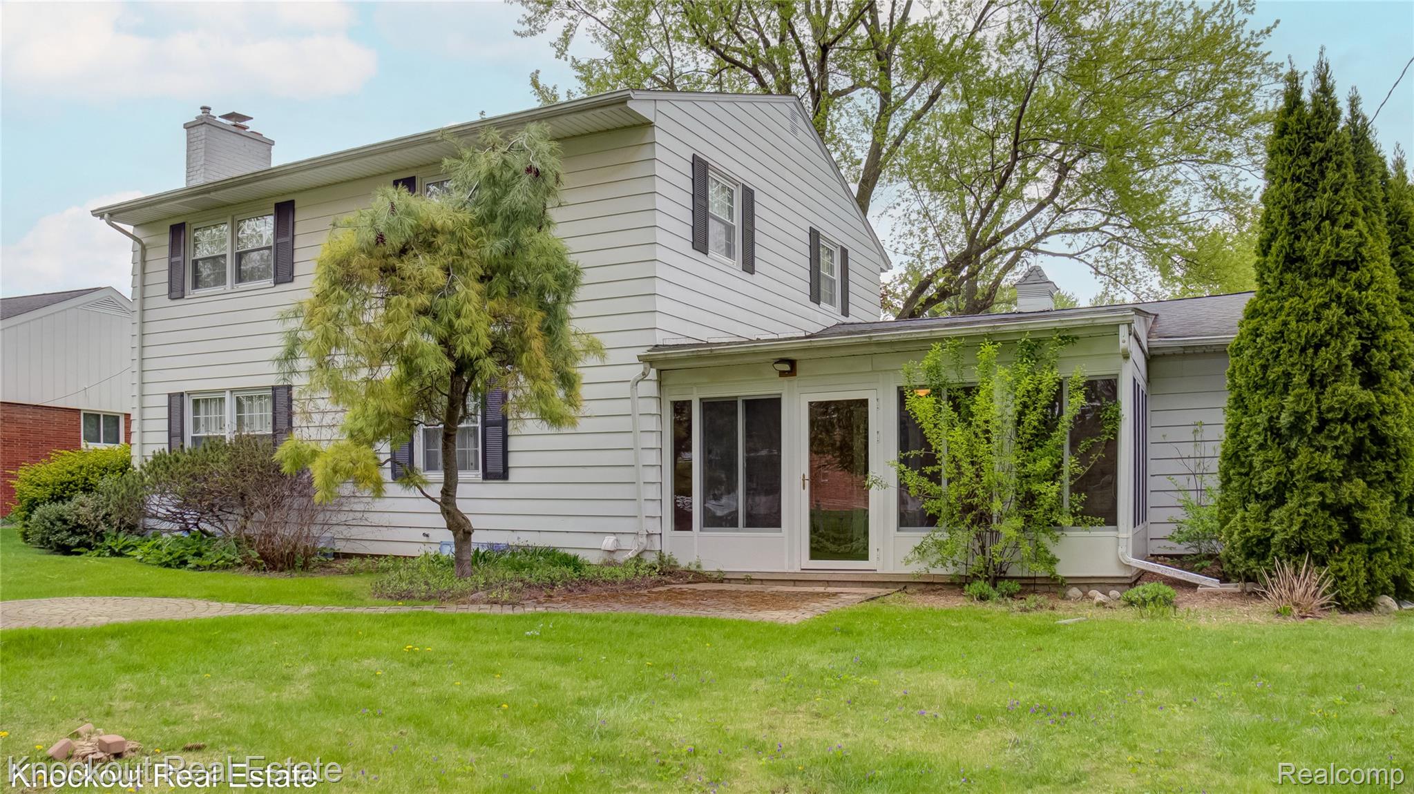 4465 Dirker Road Saginaw, MI 48638 - Photo 47 of 56 Rear view of house featuring a chimney and a yard