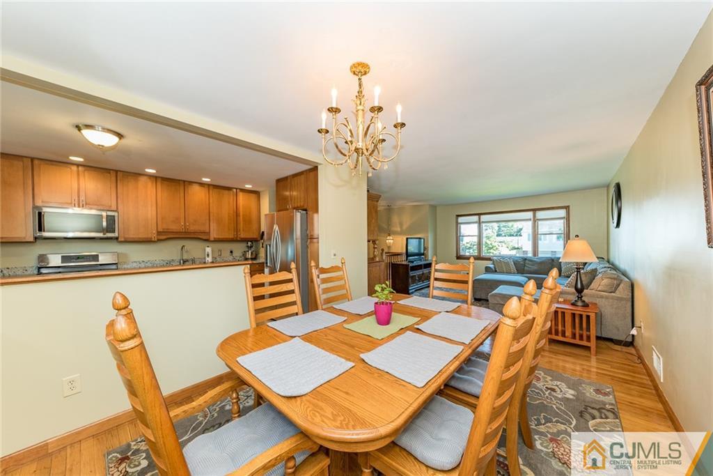 2115 Edgar Road Point Pleasant, NJ 08742 - Photo 8 of 24 a view of a dining room with furniture a chandelier and wooden floor