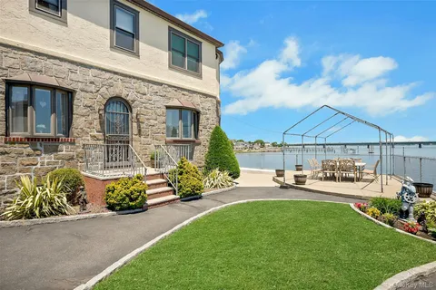 a front view of a house with patio furniture and fire pit