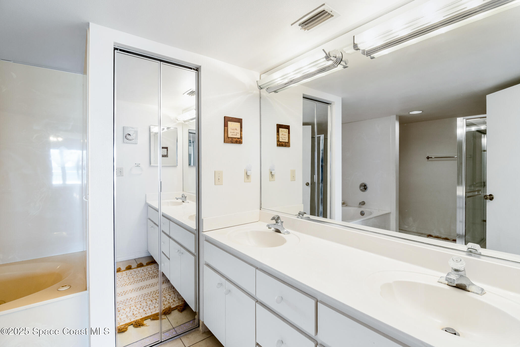 6770 Ridgewood Avenue, Unit 301 Cocoa Beach, FL 32931 - Photo 13 of 44 a bathroom with a sink and a mirror