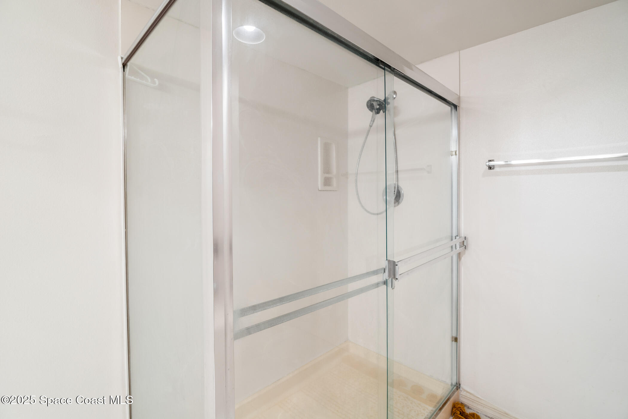 6770 Ridgewood Avenue, Unit 301 Cocoa Beach, FL 32931 - Photo 15 of 44 a bathroom with a glass shower door