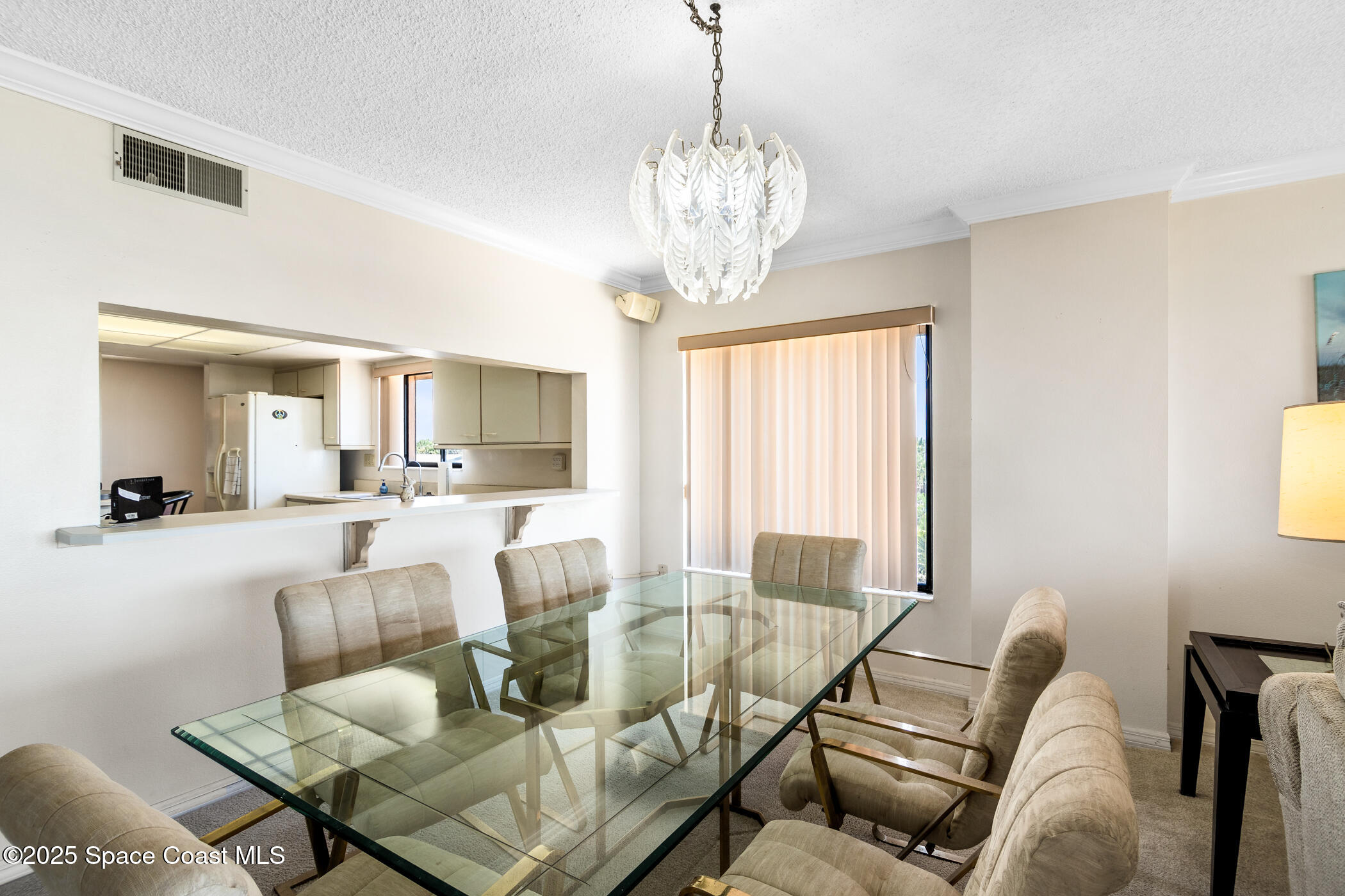6770 Ridgewood Avenue, Unit 301 Cocoa Beach, FL 32931 - Photo 17 of 44 a living room with furniture and a chandelier
