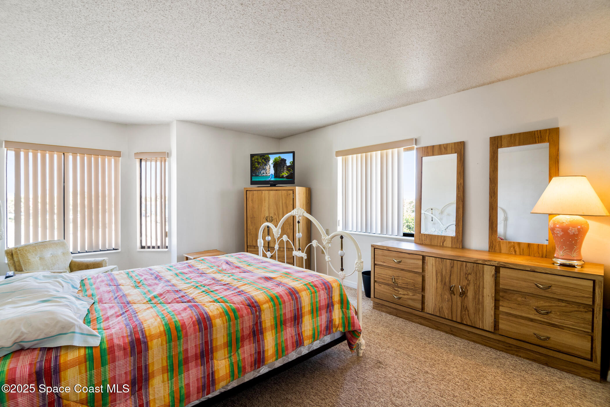 6770 Ridgewood Avenue, Unit 301 Cocoa Beach, FL 32931 - Photo 18 of 44 a bedroom with a bed and a window