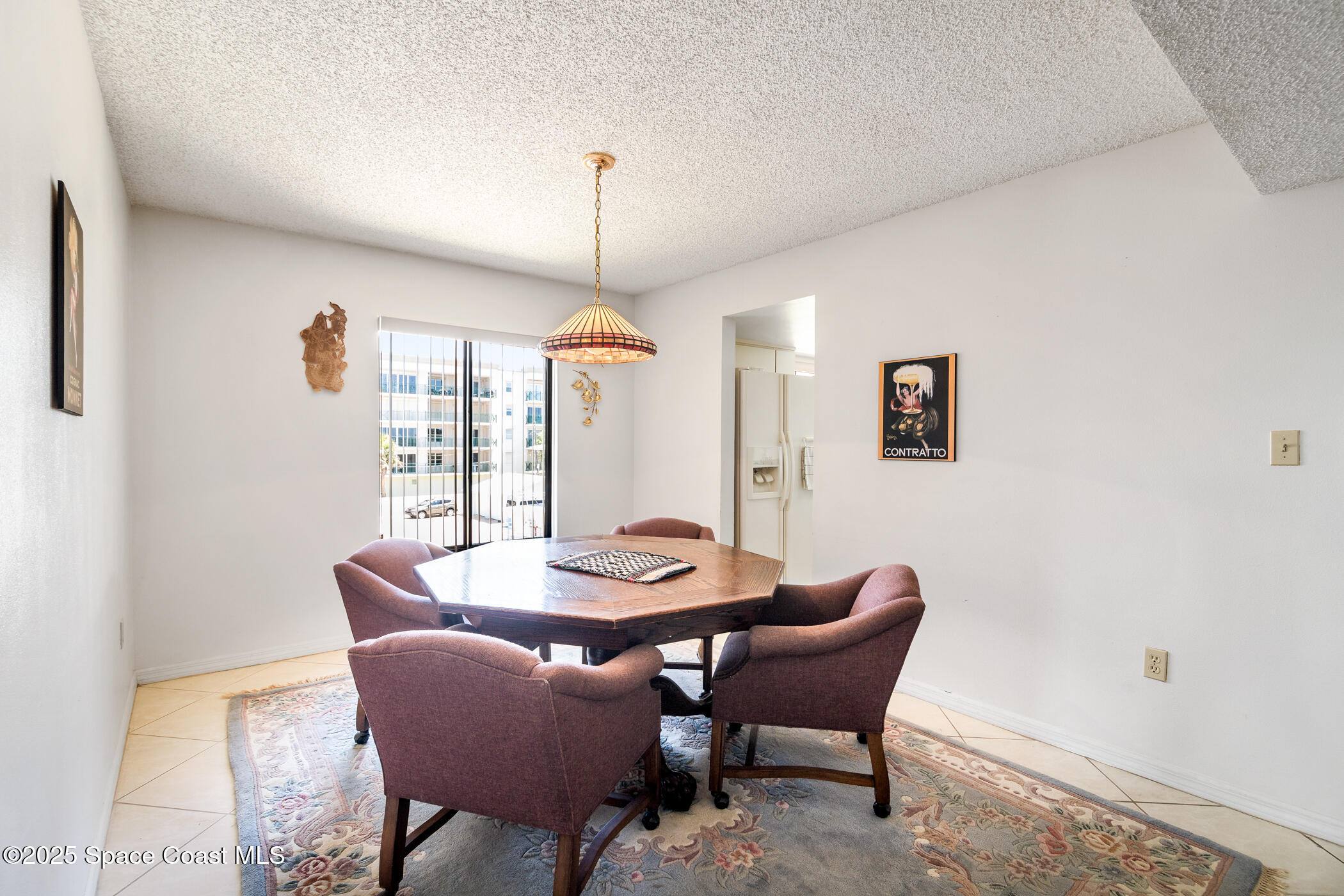 6770 Ridgewood Avenue, Unit 301 Cocoa Beach, FL 32931 - Photo 19 of 44 a dining room with furniture and window