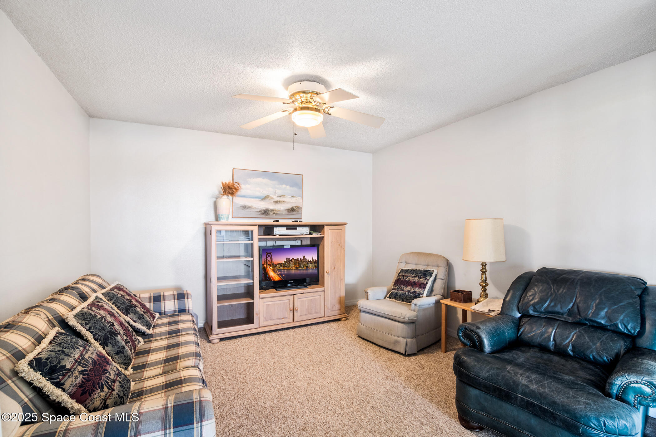 6770 Ridgewood Avenue, Unit 301 Cocoa Beach, FL 32931 - Photo 22 of 44 a bedroom with furniture and a couch