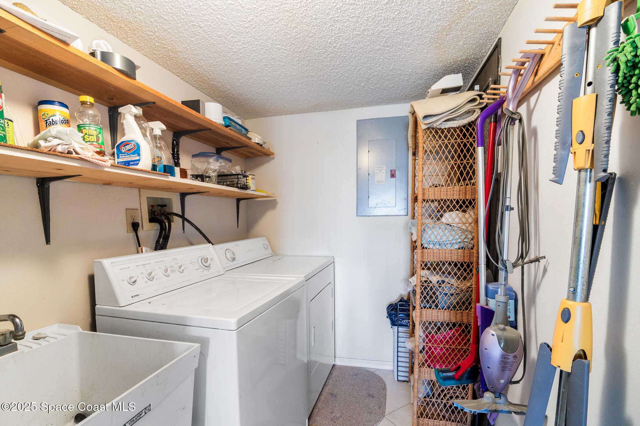 6770 Ridgewood Avenue, Unit 301 Cocoa Beach, FL 32931 - Photo 23 of 44 a utility room with dryer and washer