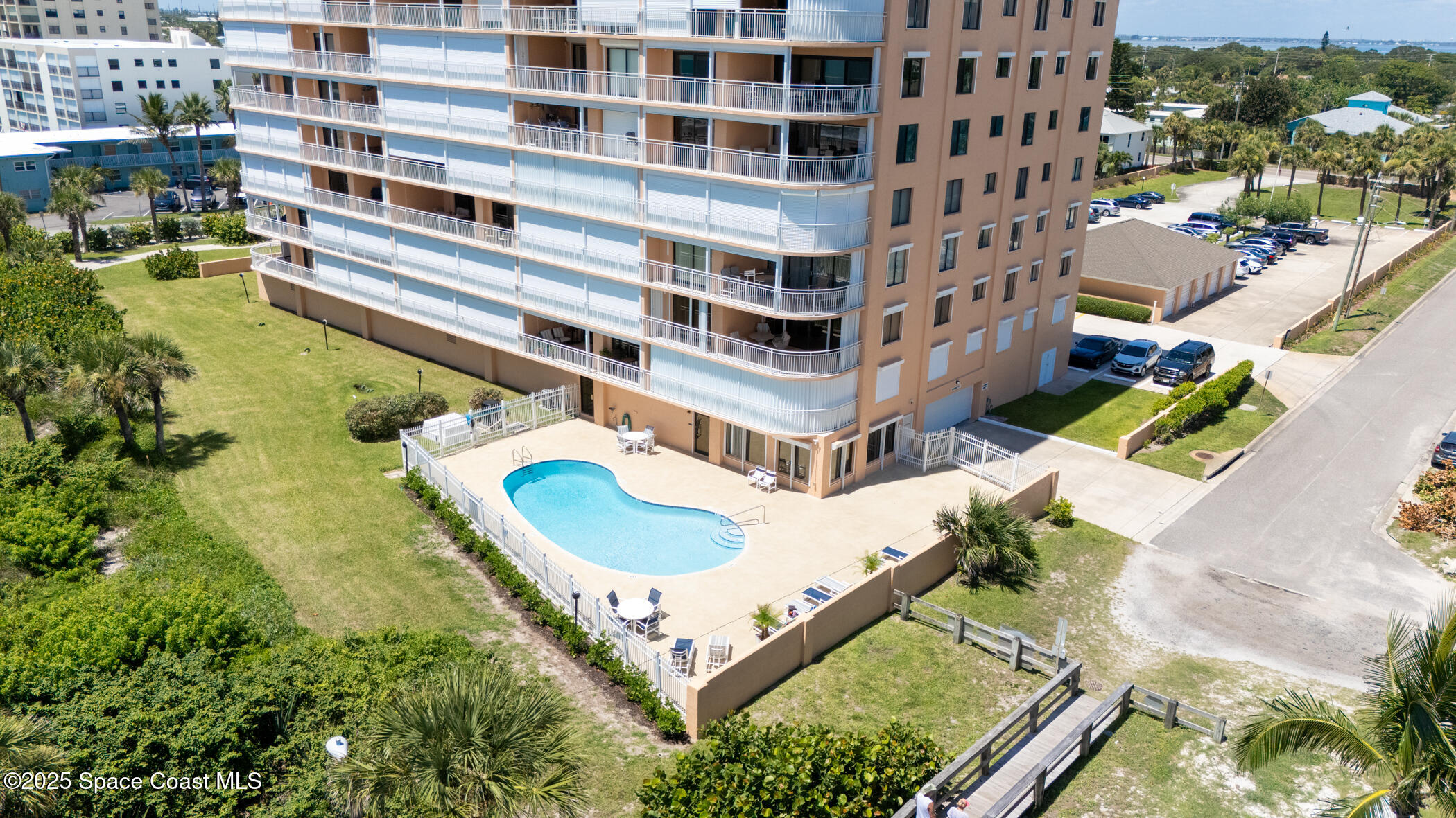6770 Ridgewood Avenue, Unit 301 Cocoa Beach, FL 32931 - Photo 3 of 44 a view of a swimming pool with a patio
