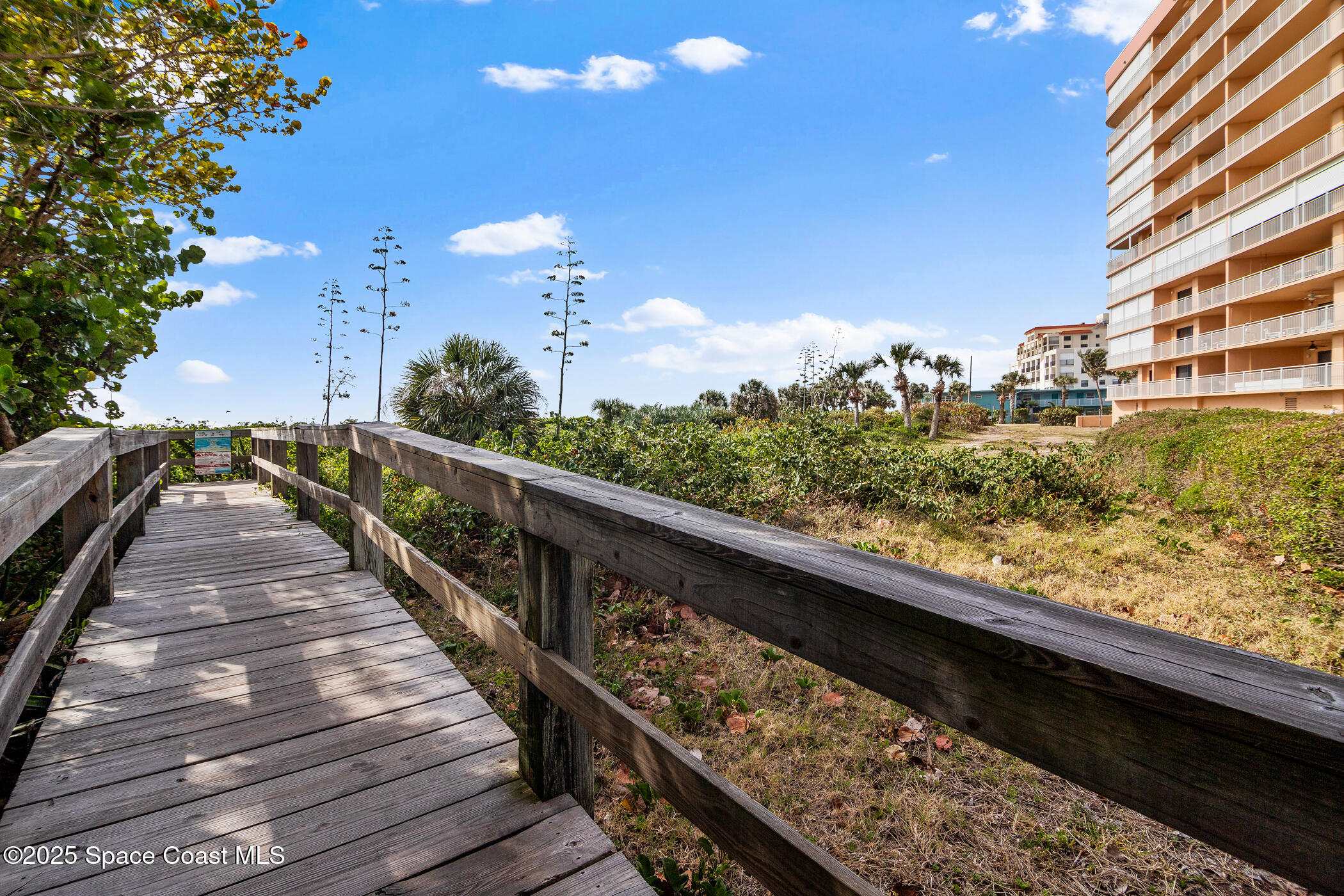 6770 Ridgewood Avenue, Unit 301 Cocoa Beach, FL 32931 - Photo 32 of 44 a view of balcony with wooden floor