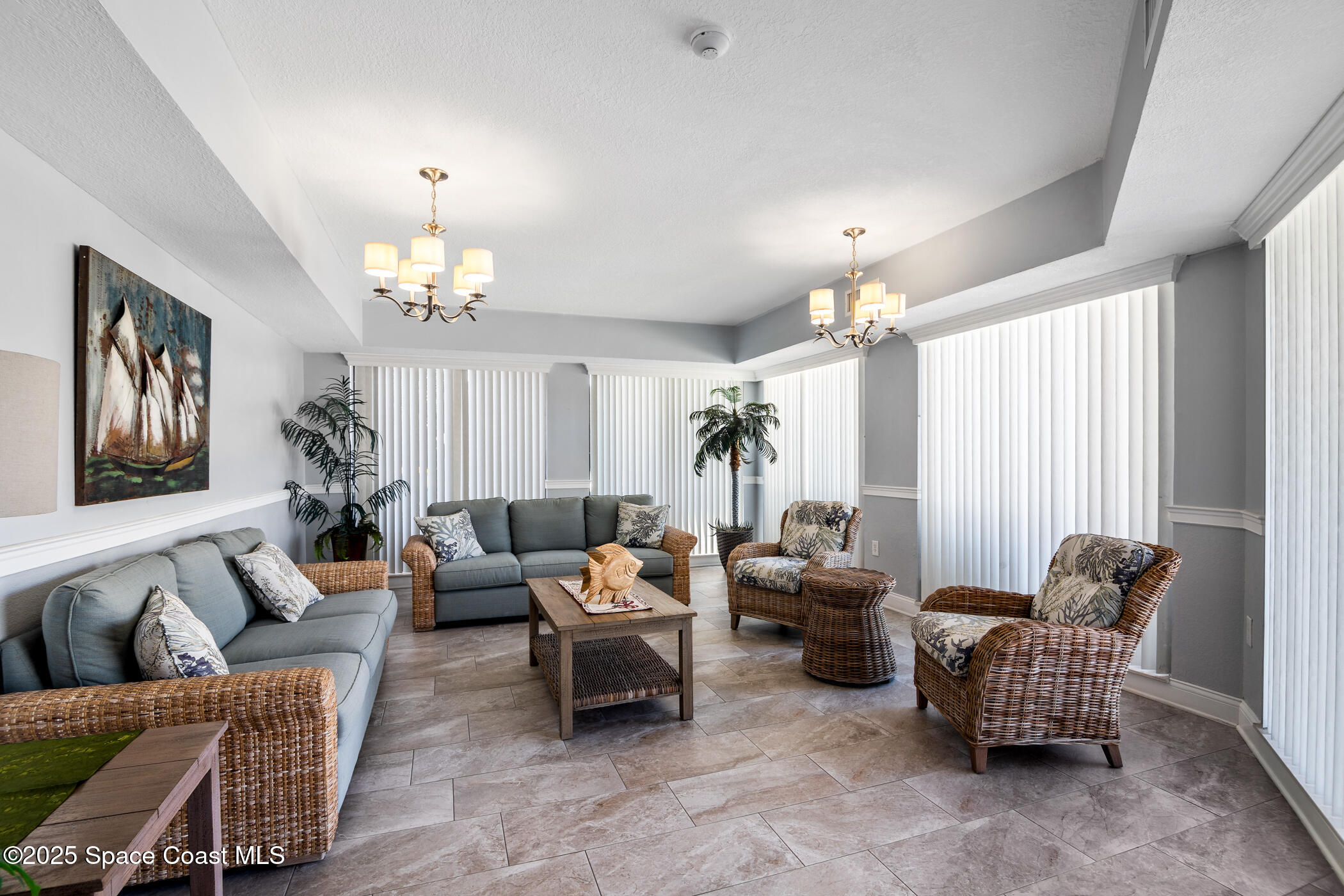 6770 Ridgewood Avenue, Unit 301 Cocoa Beach, FL 32931 - Photo 35 of 44 a living room with furniture chandelier and window
