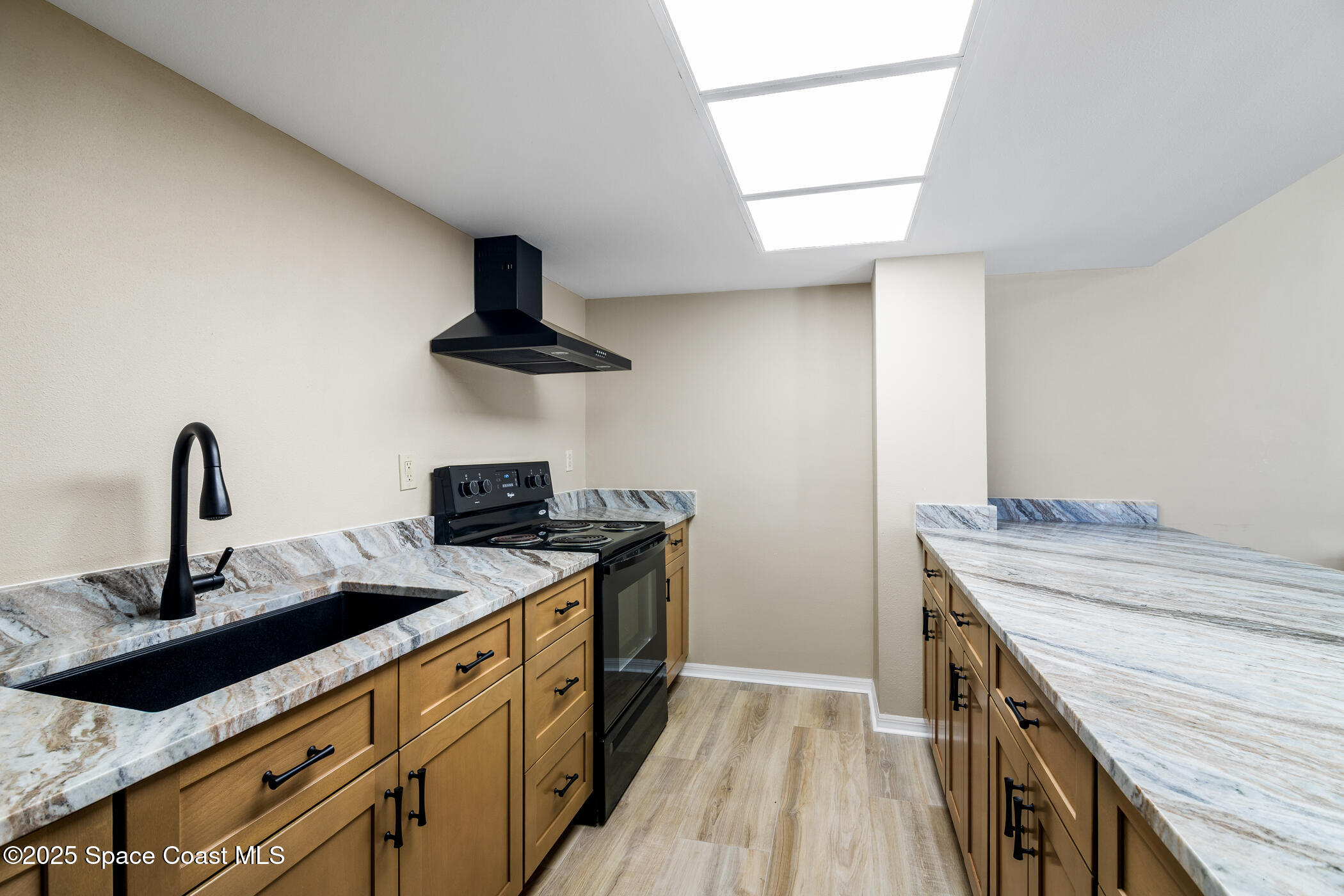 6770 Ridgewood Avenue, Unit 301 Cocoa Beach, FL 32931 - Photo 36 of 44 a kitchen with a sink and a stove
