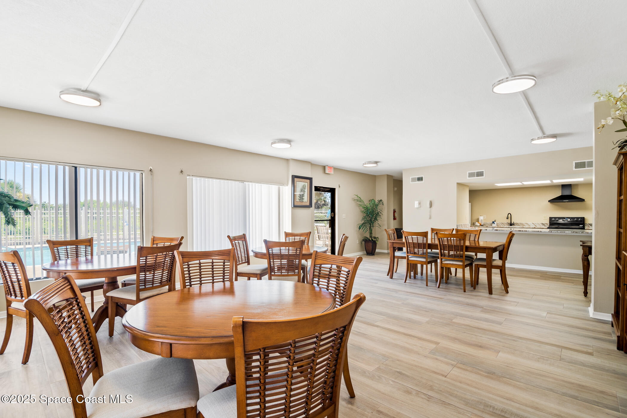 6770 Ridgewood Avenue, Unit 301 Cocoa Beach, FL 32931 - Photo 37 of 44 a dining room with furniture window and wooden floor