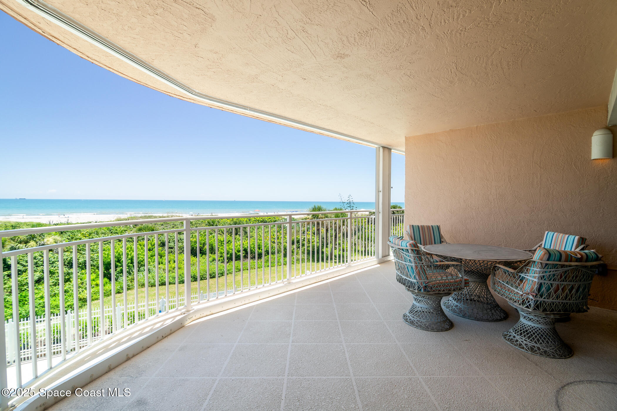 6770 Ridgewood Avenue, Unit 301 Cocoa Beach, FL 32931 - Photo 4 of 44 a room with furniture and a floor to ceiling window