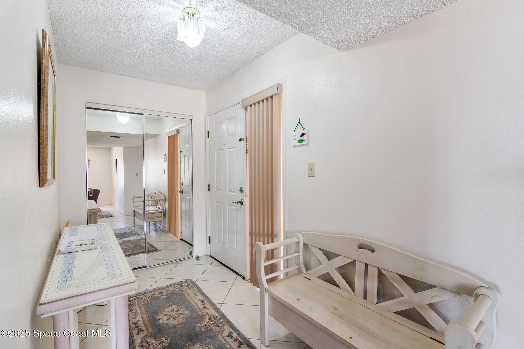 6770 Ridgewood Avenue, Unit 301 Cocoa Beach, FL 32931 - Photo 5 of 44 a view of a livingroom with furniture and entryway