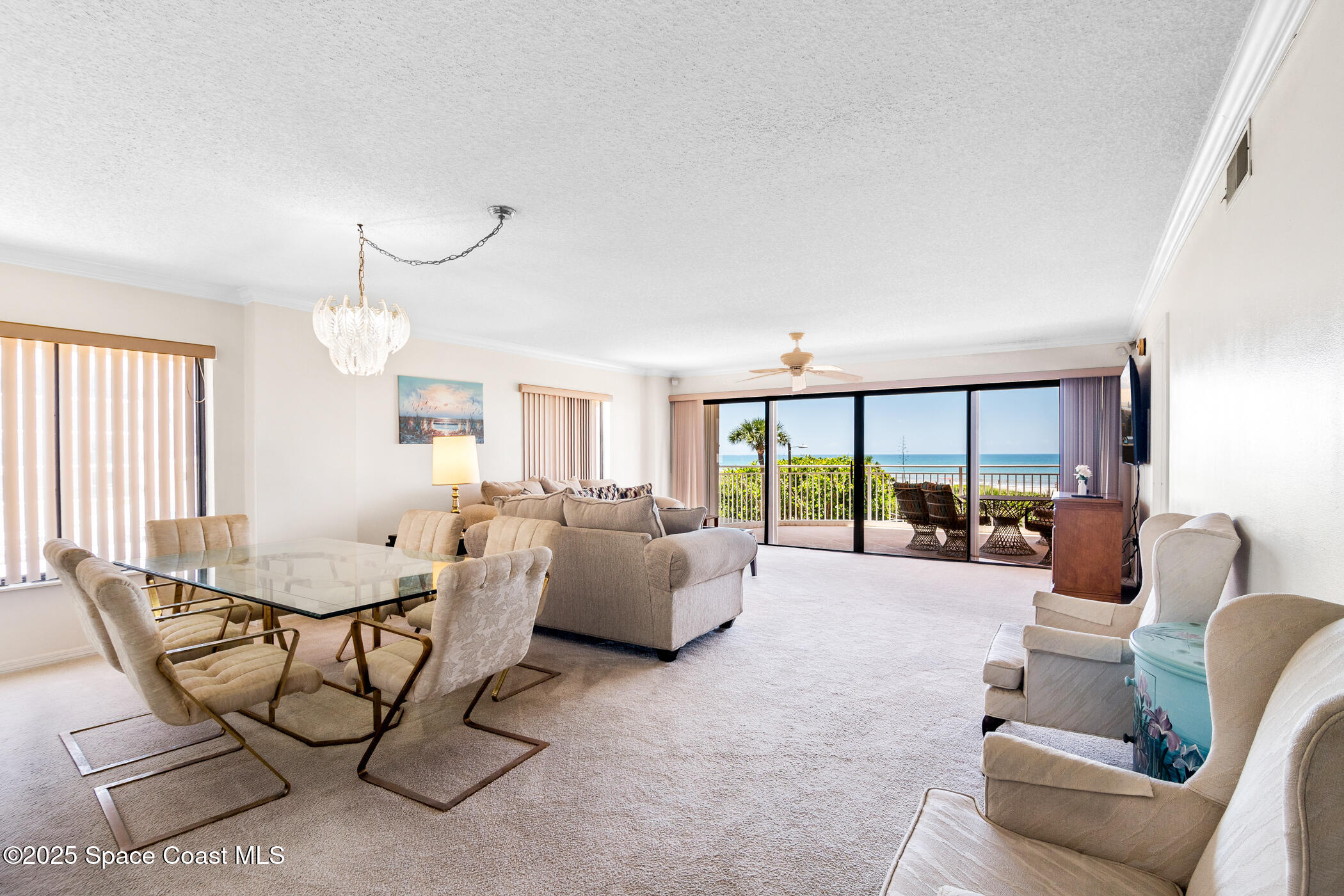 6770 Ridgewood Avenue, Unit 301 Cocoa Beach, FL 32931 - Photo 6 of 44 a living room with furniture and a large window
